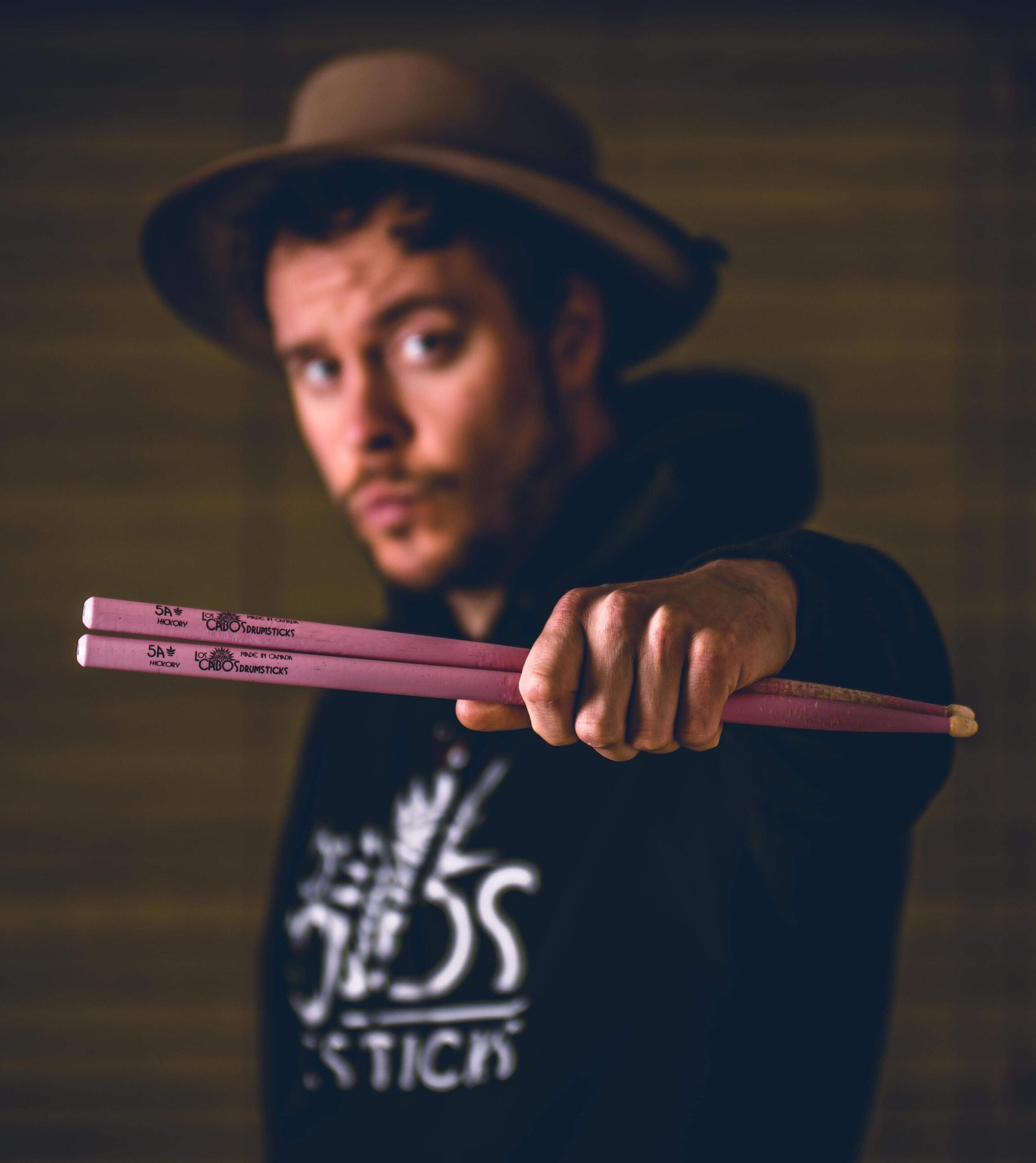 musician man holding drumsticks out in front of him